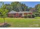 Charming brick home with well-maintained landscaping and inviting front porch at 3245 Minnesota Rd, Charlotte, NC 28208