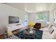 Bright living room featuring hardwood floors, stylish furniture, and a large window at 3245 Minnesota Rd, Charlotte, NC 28208