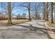 Neighborhood street view with mature trees lining the road on a sunny day at 3245 Minnesota Rd, Charlotte, NC 28208