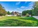 Expansive backyard featuring a well-manicured lawn, pool, and privacy fence at 7876 Rebecca Rd, Denver, NC 28037