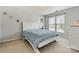 Bright bedroom with light walls, a large window, neutral carpet, and simple decor at 7876 Rebecca Rd, Denver, NC 28037