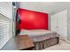 Bedroom featuring a red wall, carpet, a large bed, window, and closet at 7876 Rebecca Rd, Denver, NC 28037