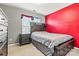 Cozy bedroom featuring a red accent wall, carpeted floors, and a built-in bed frame at 7876 Rebecca Rd, Denver, NC 28037