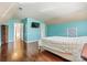 Bright bedroom with a blue accent walls, hardwood floors, television, and closet at 7876 Rebecca Rd, Denver, NC 28037