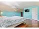 Bright bedroom with a blue accent walls, hardwood floors, television, and closet at 7876 Rebecca Rd, Denver, NC 28037