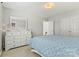 Bright bedroom with light walls, neutral carpet, a white dresser and a large window at 7876 Rebecca Rd, Denver, NC 28037