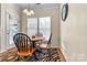 Cozy dining area with natural light, wood table, and a view to the backyard at 7876 Rebecca Rd, Denver, NC 28037