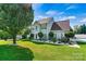 Well-maintained two-story home with a lush green lawn and manicured landscaping in a residential neighborhood at 7876 Rebecca Rd, Denver, NC 28037