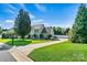 Traditional home with a long driveway, manicured lawn, and basketball court in a quiet setting at 7876 Rebecca Rd, Denver, NC 28037