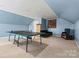 Spacious game room featuring a ping pong table and comfortable seating area at 7876 Rebecca Rd, Denver, NC 28037