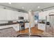 Well-lit kitchen with stainless steel appliances, granite countertops, white cabinets, and tile backsplash at 7876 Rebecca Rd, Denver, NC 28037