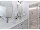 Bright bathroom featuring double sinks, modern faucets, white cabinets, and a decorative orchid for a spa-like feel at 332 Canvasback Rd, Mooresville, NC 28117