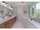 Stylish bathroom features a double vanity, soaking tub, and serene natural light at 332 Canvasback Rd, Mooresville, NC 28117