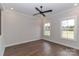 Bright bedroom with two windows, ceiling fan, neutral walls and hardwood floors, bathed in natural light at 332 Canvasback Rd, Mooresville, NC 28117