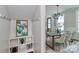 Open-concept dining room adjacent to a mudroom with hooks and shelving for storage at 332 Canvasback Rd, Mooresville, NC 28117