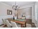 Spacious dining room featuring a rectangular wood table, neutral paint, and a stylish chandelier at 332 Canvasback Rd, Mooresville, NC 28117