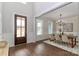 Elegant dining room with hardwood floors, wainscoting, a decorative light fixture, and ample natural light at 332 Canvasback Rd, Mooresville, NC 28117
