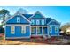 Two-story blue house with white trim, covered porch, and large windows at 332 Canvasback Rd, Mooresville, NC 28117