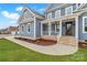 Eye-catching blue exterior with a covered porch, brick accents, and a sidewalk leading to the entrance at 332 Canvasback Rd, Mooresville, NC 28117