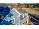 Partial view of a two-story blue house showing a dormer and roofline at 332 Canvasback Rd, Mooresville, NC 28117