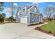 Home exterior with a wide driveway leading to a garage, complemented by well-maintained landscaping at 332 Canvasback Rd, Mooresville, NC 28117