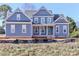 Two-story house with blue siding, white trim, and a covered porch at 332 Canvasback Rd, Mooresville, NC 28117