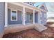 Covered front porch with brick steps and wooden columns at 332 Canvasback Rd, Mooresville, NC 28117