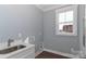 Functional laundry room with a sink, white cabinets, and a window providing natural light at 332 Canvasback Rd, Mooresville, NC 28117