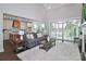 Spacious living area showcasing the fireplace, comfortable seating, and the seamless connection to the outdoor patio at 332 Canvasback Rd, Mooresville, NC 28117