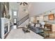 Open-concept living room featuring a fireplace, staircase, and seamless flow to the kitchen area at 332 Canvasback Rd, Mooresville, NC 28117