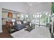 Bright living room with a fireplace, hardwood floors, and sliding doors to outdoor patio at 332 Canvasback Rd, Mooresville, NC 28117