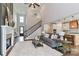 Bright living room showcases a fireplace, staircase, and seamless transition to the modern kitchen at 332 Canvasback Rd, Mooresville, NC 28117