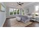 Tranquil main bedroom boasts tray ceilings, large windows, and a calming color palette at 332 Canvasback Rd, Mooresville, NC 28117