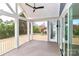 Open-air porch with painted gray flooring, white railing, and view of trees at 332 Canvasback Rd, Mooresville, NC 28117