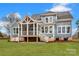 Charming home featuring a screened porch and a well-maintained lawn and professional landscaping at 332 Canvasback Rd, Mooresville, NC 28117