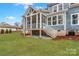 Covered and screened-in back porch overlooking the backyard, providing a comfortable and bug-free outdoor living space at 332 Canvasback Rd, Mooresville, NC 28117