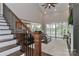 Elegant staircase leading to the upper level, with views of the open-concept living area and abundant natural light at 332 Canvasback Rd, Mooresville, NC 28117