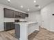 Modern kitchen with dark cabinetry, quartz countertops, and island at 335 Bezelle Ave, York, SC 29745