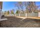 Large backyard featuring a tall gray privacy fence, grass, and mature trees at 225 English Arbor Dr # 13, Fort Mill, SC 29715