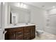 Bright bathroom featuring a double vanity with dark wood cabinets, and a large mirror reflecting neutral walls at 225 English Arbor Dr # 13, Fort Mill, SC 29715