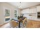 Bright dining area featuring hardwood floors, stylish table setting, and direct access to the backyard at 225 English Arbor Dr # 13, Fort Mill, SC 29715