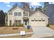 Charming two-story home with a manicured lawn, two car garage, and inviting blue front door at 225 English Arbor Dr # 13, Fort Mill, SC 29715