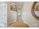 Bright hallway featuring hardwood floors, a staircase with iron railings, and an elegant round mirror at 225 English Arbor Dr # 13, Fort Mill, SC 29715