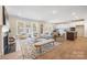 Spacious living room open to the kitchen, featuring hardwood floors, a fireplace, and natural light at 225 English Arbor Dr # 13, Fort Mill, SC 29715