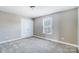 Bright bedroom featuring a window with blinds and double closet at 4302 Ethel Sustar Dr, Monroe, NC 28110