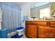 Classic bathroom with a wood vanity, blue accents, and a walk-in shower at 102 Cedar Hollow St, Fort Mill, SC 29715
