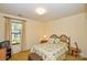 Cozy bedroom featuring a comfortable floral-patterned bed and a bright window view at 102 Cedar Hollow St, Fort Mill, SC 29715