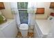 Bright laundry room with washer, dryer, and natural light from the exterior window at 102 Cedar Hollow St, Fort Mill, SC 29715