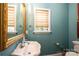 Elegant bathroom with a pedestal sink and tranquil teal walls at 2594 Knoll Ridge Ct, Hickory, NC 28602