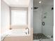 Spa-like bathroom featuring a soaking tub and a walk-in shower at 2594 Knoll Ridge Ct, Hickory, NC 28602